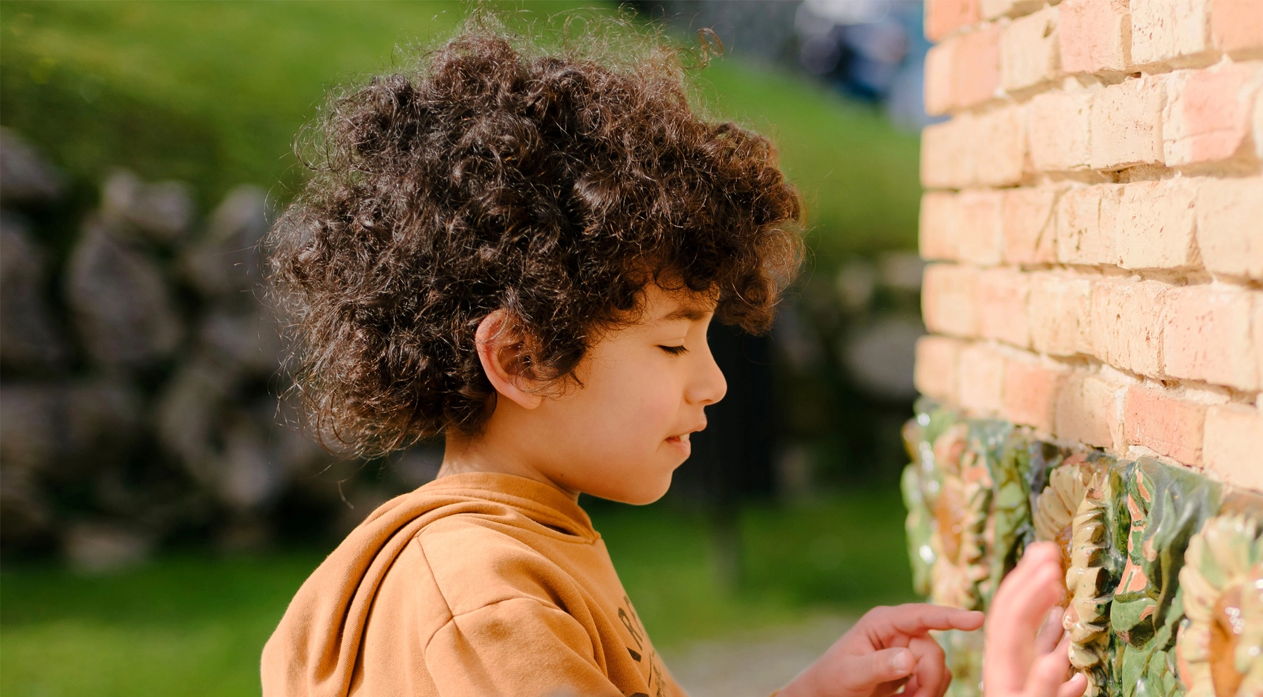 A boy interacting with the sunflower tiles