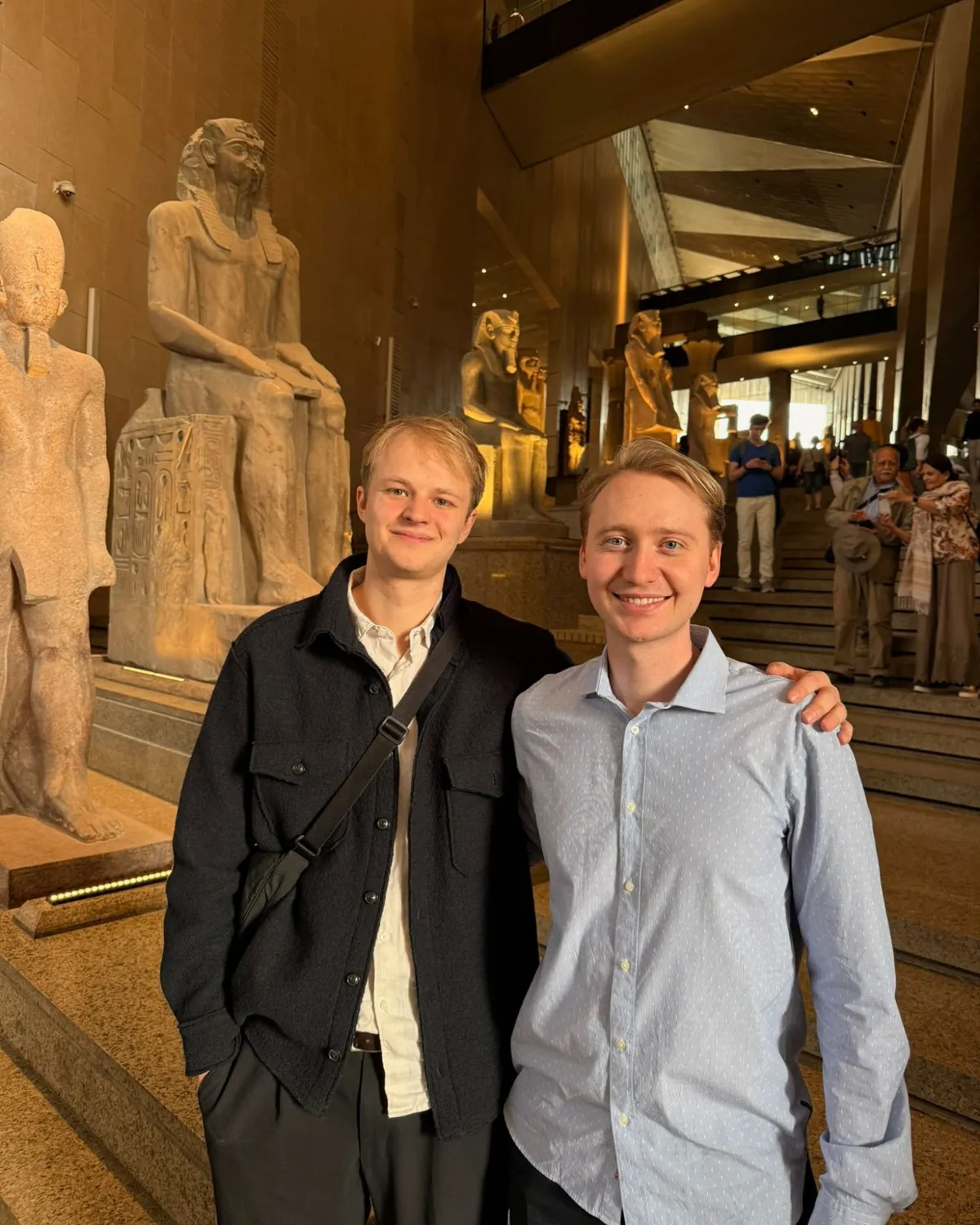Christoph Renschler and Hendrik Schäfer in a museum hall lined with ancient Egyptian statues
